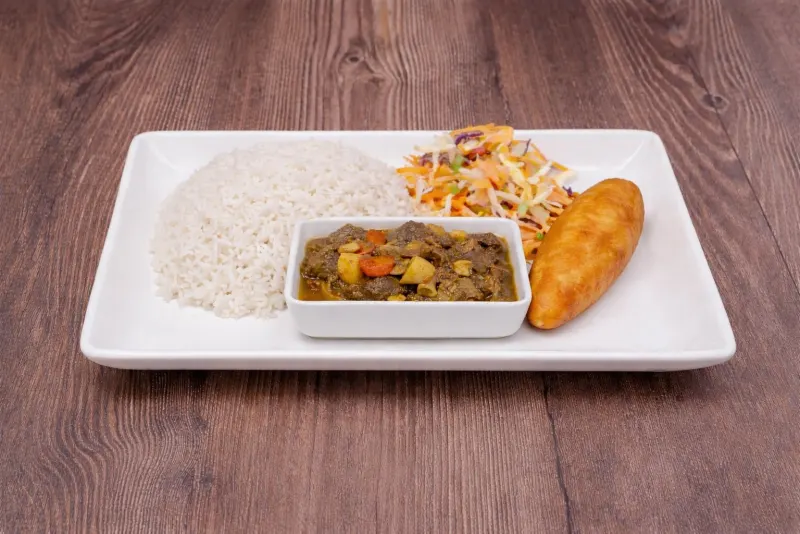 Curry with white rice, coleslaw and a patty